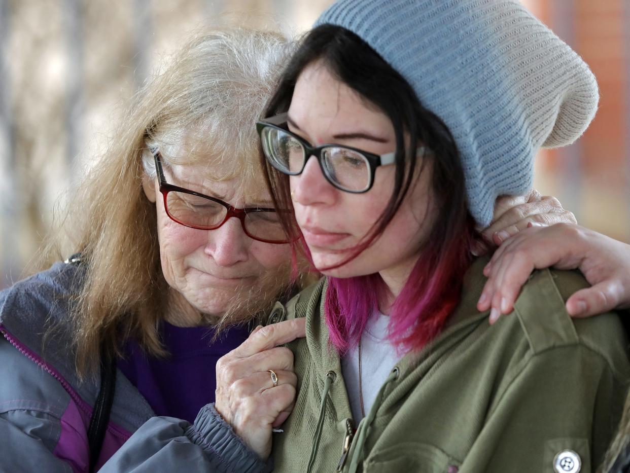 Linda Devers, left, weeps on the shoulder of her granddaughter Alexis Weingarth as she speaks about the loss of her brother, Jerry, who was killed in a hit-skip accident in Akron days before Christmas. The case remains unsolved.