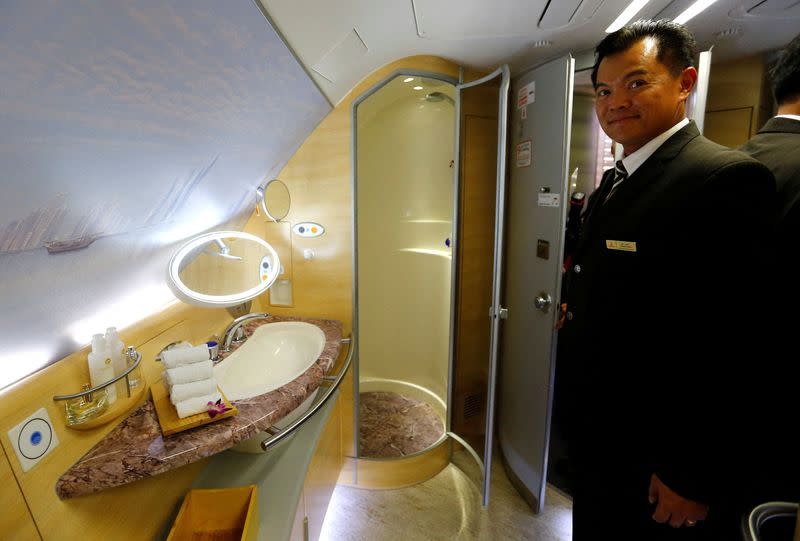 FILE PHOTO: A flight attendant presents the spa area with a shower for first class passengers of United Arab Emirates air carrier Emirates after the first landing of an Emirates Airbus A380 in Frankfurt's airport