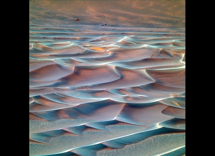 Sometimes use the rovers' UV and infrared imaging capability to create "false color" images of martian terrains, like this view of sand dunes at the bottom of Endurance crater. False color photos are scientifically useful, but they are often just as valuable as garish and lovely  artistic renderings that would make Andy Warhol proud...   <em>  Opportunity rover Pancam image, mission sol 207 (August 23, 2004).  From "Postcards from Mars" by Jim Bell; Photo credit: NASA/JPL/Cornell University  </em>