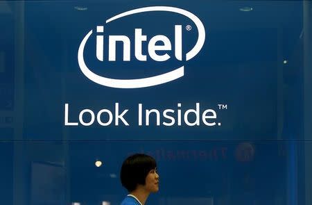 An employee walks past an Intel logo during the 2014 Computex exhibition at the TWTC Nangang exhibition hall in Taipei June 3, 2014. Computex, the world's second largest computer show, runs from June 3 to 7. REUTERS/Pichi Chuang