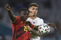 Belgium's Jeremy Doku, left, challenges for the ball with Italy's Giovanni Di Lorenzo during a Euro 2020 soccer championship quarterfinal match between Belgium and Italy at the Allianz Arena in Munich, Germany, Friday, July 2, 2021. (Andreas Gebert/Pool Photo via AP)