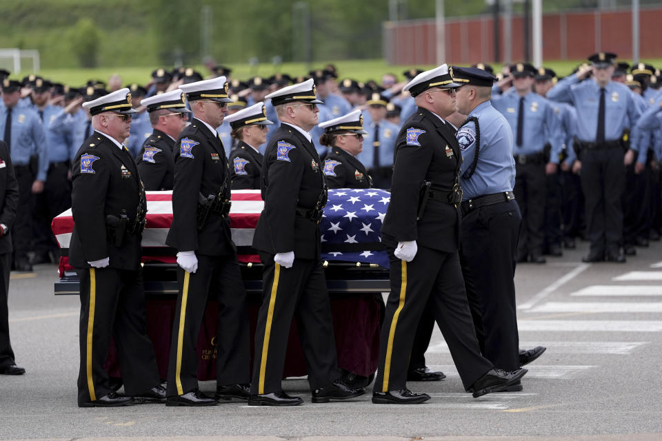 Members of an honor guard transfer the casket Minneapolis police Officer Jamal Mitchell from a caisson after arriving for his public memorial service at Maple Grove Senior High School, Tuesday, June 11, 2024, in Maple Grove, Minn. Mitchell was shot and killed while responding to a shooting on May 30, 2024. (AP Photo/Abbie Parr, Pool)