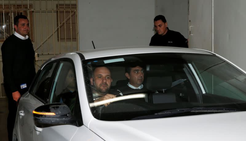 Melvin Theuma, who allegedly acted as a middle man in a plot to murder of journalist Daphne Caruana Galizia, is seen in a police car as he leaves the Courts of Justice in Valletta