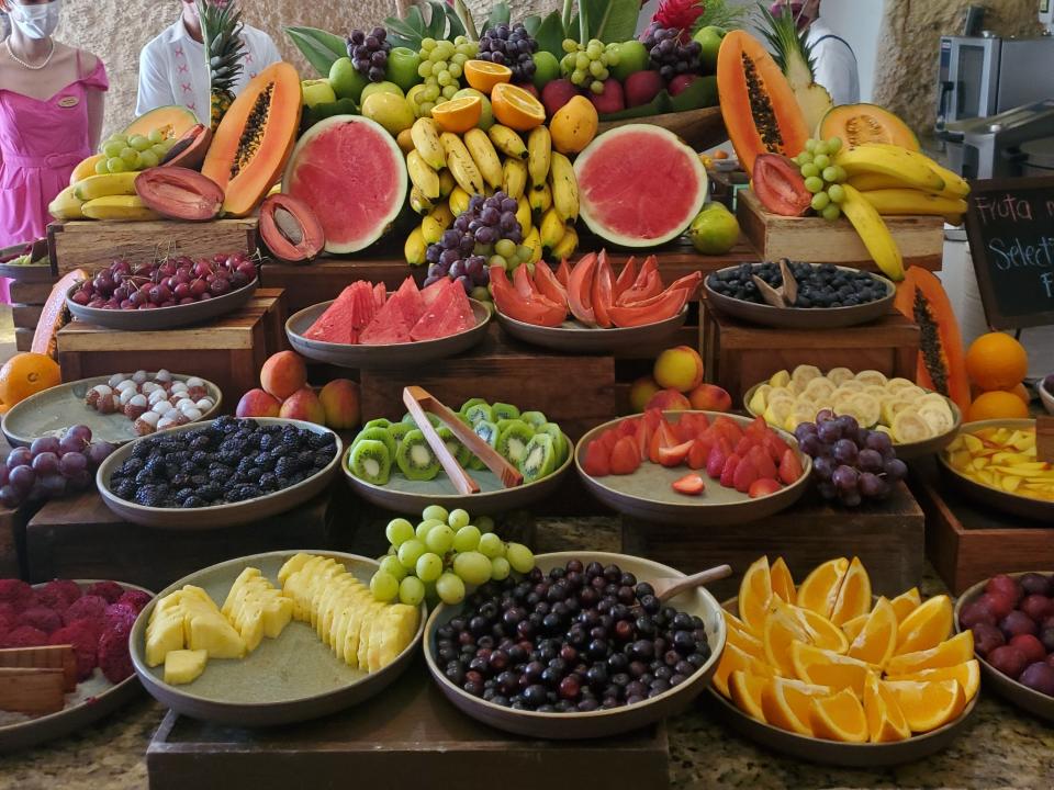 A table covered in bowls of different fruits.