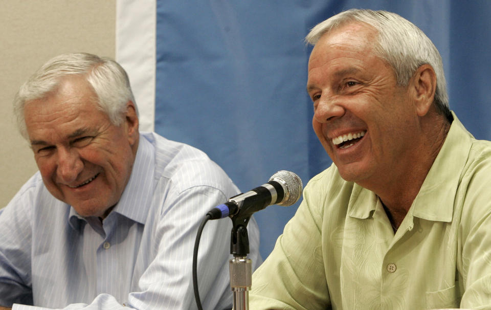 FILE - Former North Carolina coach Dean Smith, left, and current coach Roy Williams smile during a news conference in Chapel Hill, N.C., Wednesday, Sept. 5, 2007. (AP Photo/Gerry Broome, File)