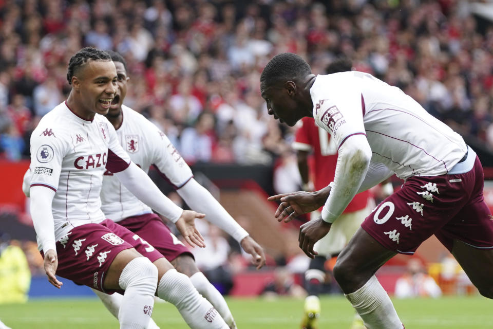 Aston Villa's Kortney Hause, right, celebrates after scoring his side's opening goal during the English Premier League soccer match between Manchester United and Aston Villa at the Old Trafford stadium in Manchester, England, Saturday, Sept 25, 2021. (AP Photo/Jon Super)