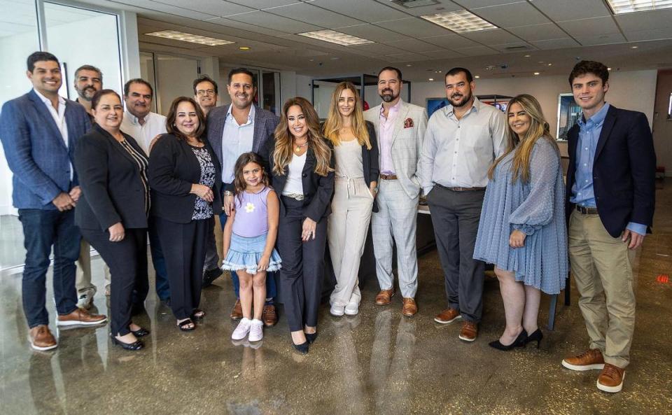 ‘This office is just a box if it didn’t have the people that were here every day. For that I am really grateful, for my team, because it is really about them,’ says Lissette Calderon in the center surrounded by her team of employees on Oct. 20, 2023.