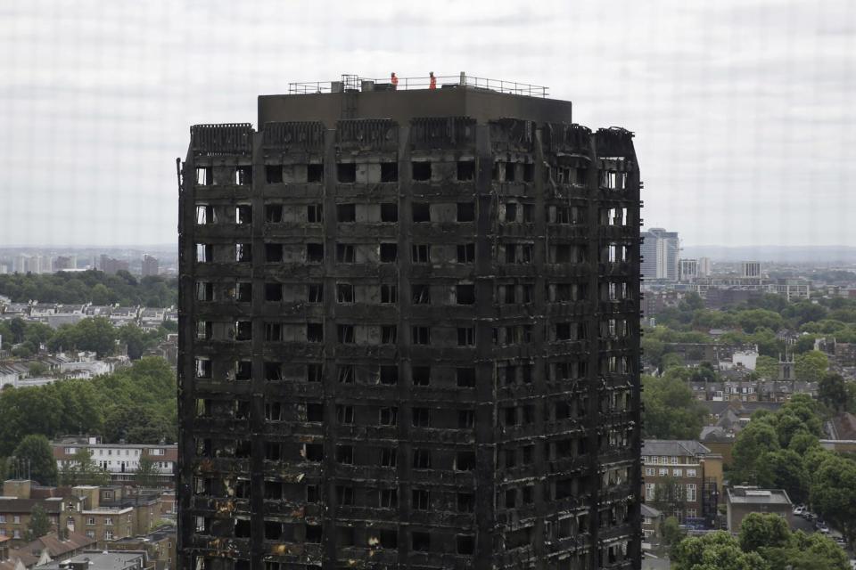 Forensic: officials at work on the top of the remains of Grenfell tower