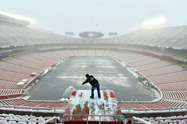 <p>AP Photo/Ed Zurga</p> Snow is cleared in Arrowhead Stadium in January 2019.