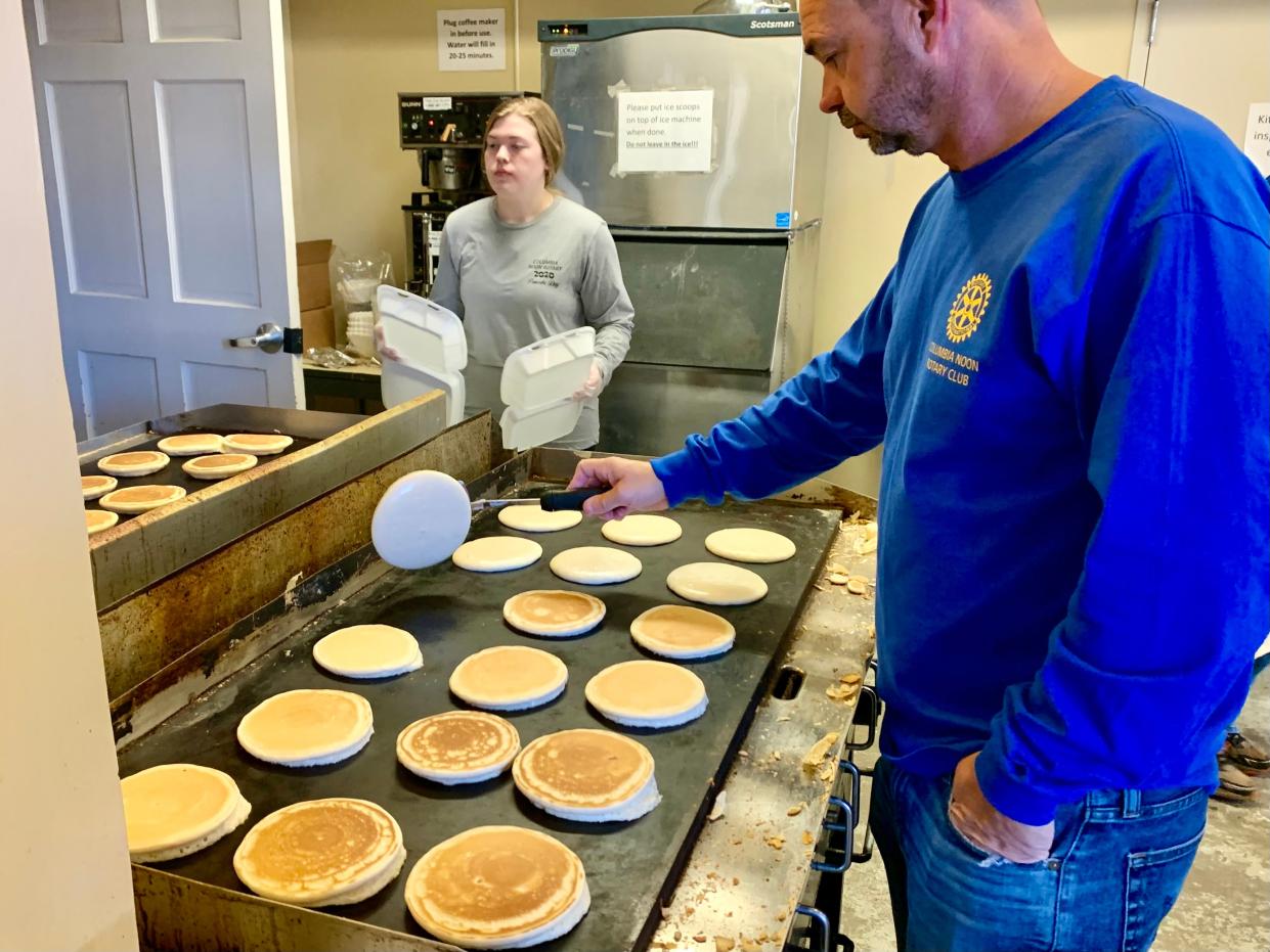 Jeremy Baker of Columbia Noon Rotary flips a batch of "secret recipe" pancakes at the 62nd annual Rotary Pancake Day.