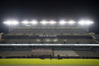 The Texas A&M University Yell Leaders kneel at midfield as part of the first Midnight Yell Practice this season in Kyle Field, College Station, Texas early Saturday, Sept. 26, 2020. Due to Coronavirus restrictions, the Texas A&M Band were the only crowd allowed in the normally packed stands for the traditional game day event in College Station, Texas. (Sam Craft/Texas A&M University via AP, Pool)