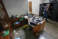 FILE - Confidencial director Carlos Fernando Chamorro, son of former President Violeta Barrios de Chamorro, walks through his ransacked offices while talking on his cellphone in Managua, Nicaragua, Dec. 14, 2018. In 2018 the government raided the headquarters of the newspaper Confidencial, led by journalist Carlos Fernando Chamorro, who is considered one of the most prominent critics of Ortega. (AP Photo/Alfredo Zuniga, File)