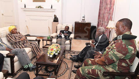 President Robert Mugabe (C) in a meeting with the ZDF Commander General Constantino Chiwenga, South African Minister of Defence Minister Nosiviwe Mapisa-Nqakula (in yellow head gear), Zimbabwe Defence Minister Dr Sydney Sekeramayi and Zimbabwe State Security Minister Cde Kembo Mohadi at State House in Harare, Zimbabwe, November 16, 2017. ZIMPAPERS/Handout via REUTERS