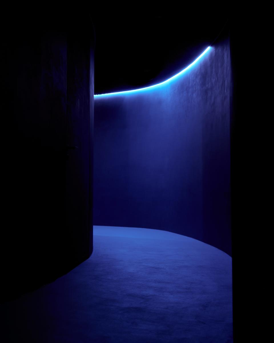 A blue-lit hallway at Restaurant Iris.