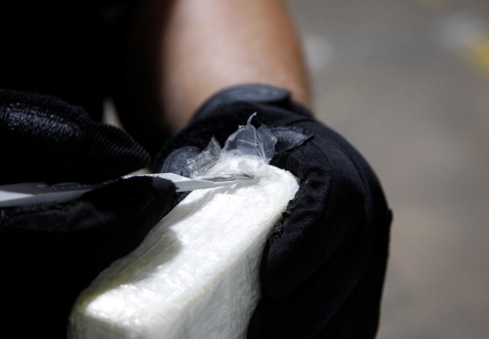 An agent cuts open a brick of some the 35,000 pounds (15,875 kg) of cocaine that U.S. Customs and Border Protection and Homeland Security Investigations seized on the MSC Gayane in seven shipping containers in Philadelphia, Pennsylvania, U.S. June 17, 2019. Picture taken June 17, 2019.  Steve Sapp/courtesy of U.S. Customs and Border Protection/Handout via REUTERS. ATTENTION EDITORS - THIS IMAGE WAS PROVIDED BY A THIRD PARTY