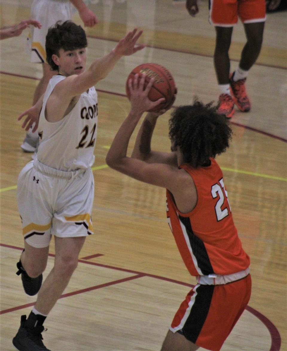 Cooper's Trevor Ollier defends as Cooper defeated Ryle 52-45 Jan. 21, 2022.