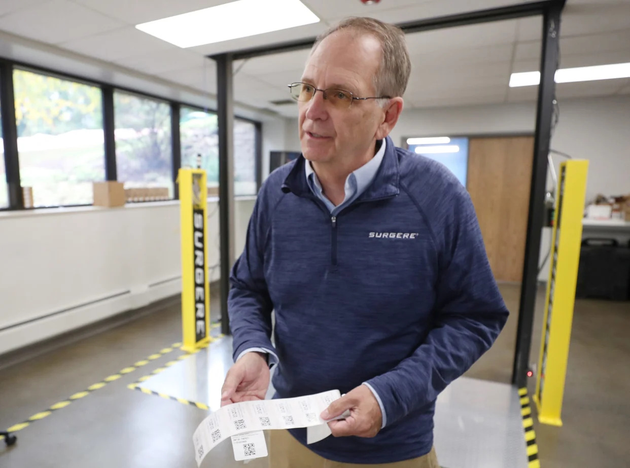 Charles Dressler, President of Surgere, explains how encoded RIFD tags work as he stands in front of a mock up loading dock equipped with Surgere Portal and Dock Door Scanners.