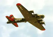 FILE - The historic military B-17 aircraft named "Texas Raiders" flies over Barksdale A.F.B., La., on May 8, 2021. On Saturday, Nov. 12, 2022, the plane collided with another during the Commemorative Air Force Wings Over Dallas air show. (AP Photo/Dr. Scott M. Lieberman)