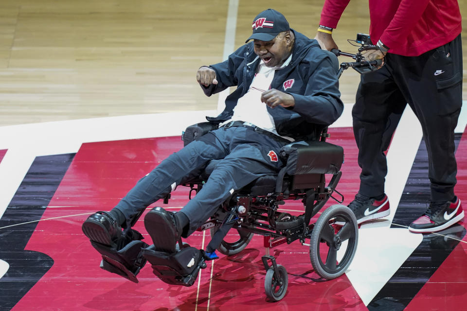 Former Wisconsin player and assistant coach Howard Moore is greeted Saturday, March 2, 2024, in Madison, Wis., with a standing ovation in his first public appearance at the Kohl Center since a 2019 car wreck killed his wife and daughter and left him with serious injuries. (AP Photo/Andy Manis)