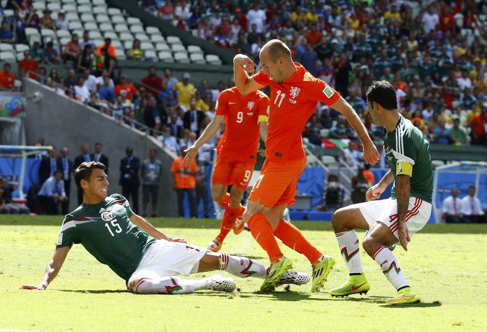 Robben of the Netherlands is challenged by Mexico's Moreno and Marquez during their 2014 World Cup round of 16 game at the Castelao arena in Fortaleza