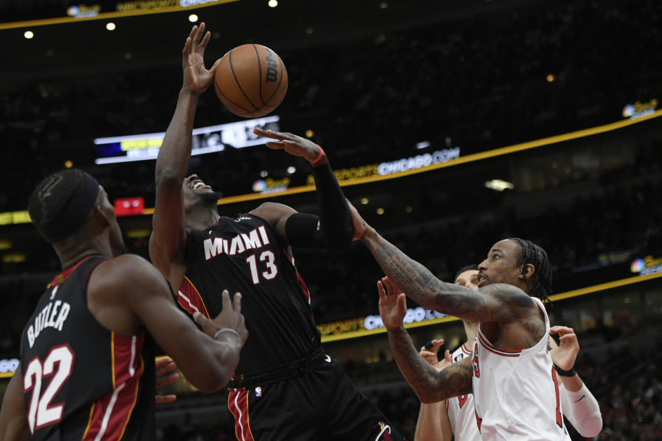 Chicago Bulls' DeMar DeRozan (11) fouls Miami Heat's Bam Adebayo (13) while battling for a rebound during the second half of an NBA basketball game, Saturday, March 18, 2023, in Chicago. Chicago won 113-99. (AP Photo/Paul Beaty)