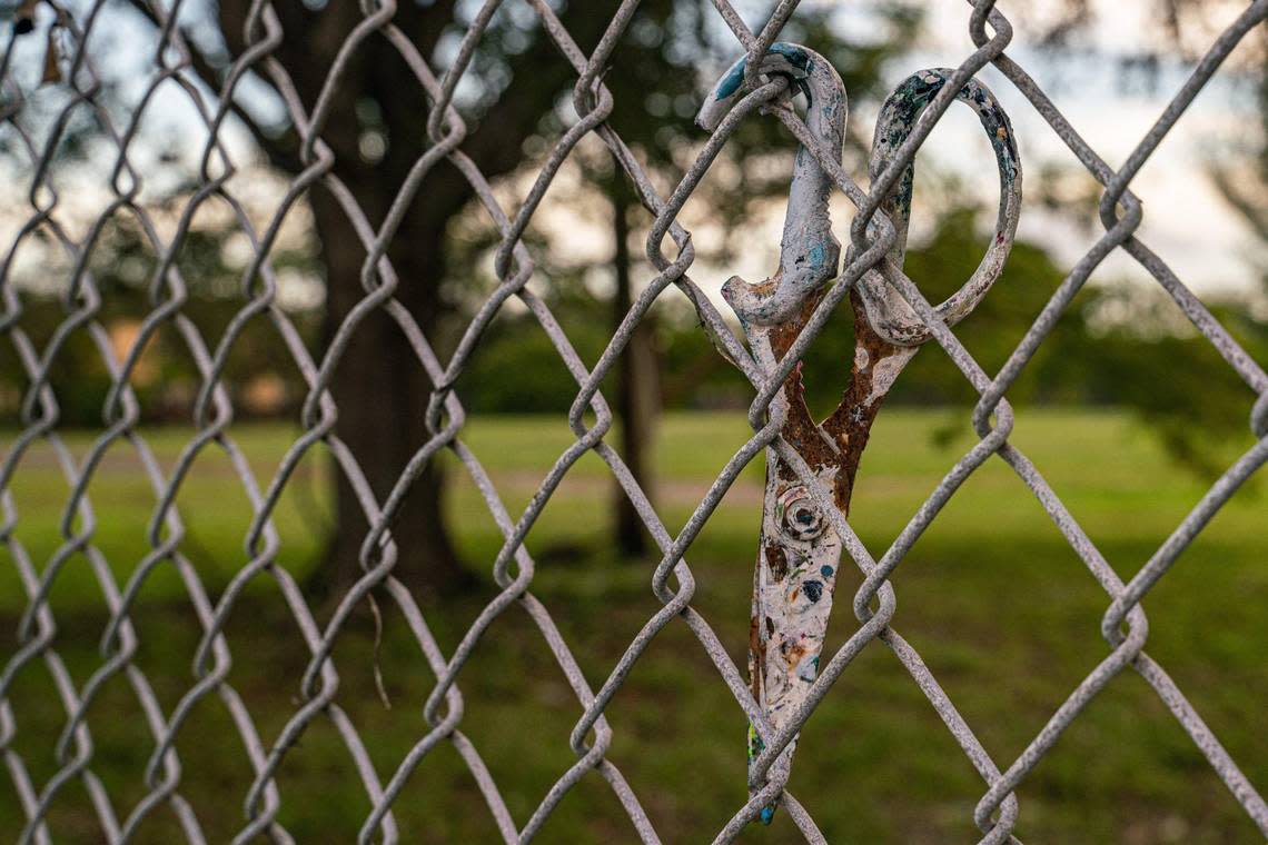 Scissors are rusted on the fence of the empty lot on Northwest 74th Street and Northwest 25th Avenue in Miami on Nov. 30, 2022. The county-owned land is sought by two competing development groups.