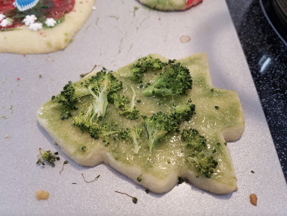 A Christmas cookie with broccoli on top