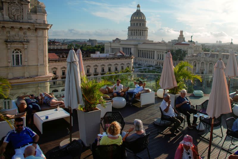FILE PHOTO: Tourists are seen on a rooftop hotel in Havana