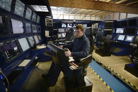 An engineer sits in the control room being constructed for the subsea mining machines Soil Machine Dynamics (SMD) is building for Nautilus Minerals at Wallsend, northern England April 14, 2014. REUTERS/ Nigel Roddis