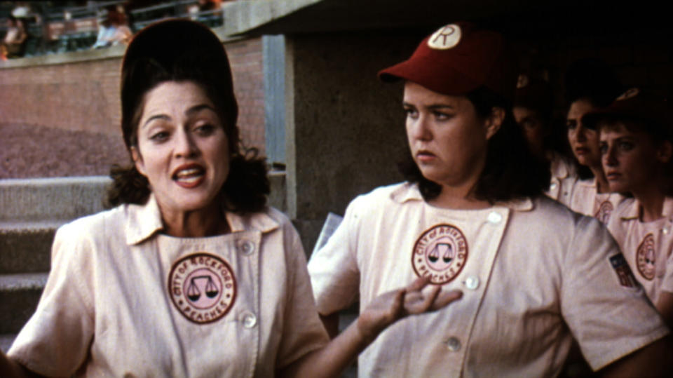 Madonna and Rosie O'Donnell in baseball uniforms, talking