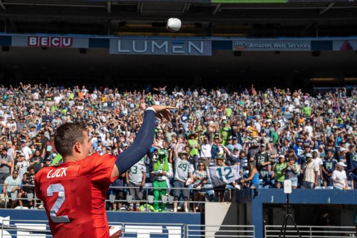 Seattle Seahawks quarterback Drew Lock throws a signed ball into the crowd for fans who came to their mock game in Lumen Field on Saturday Aug. 6, 2022.