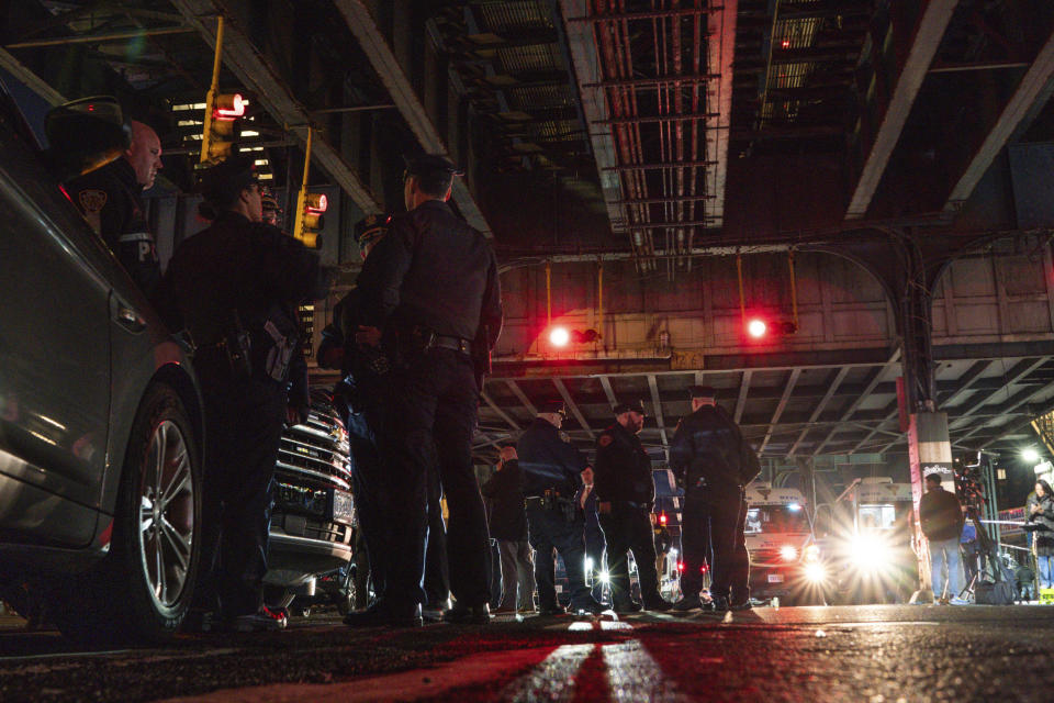 Police officers gather after a shooting at the Mount Eden Avenue subway station, Monday, Feb. 12, 2024, in the Bronx borough of New York. (AP Photo/Eduardo Munoz Alvarez)