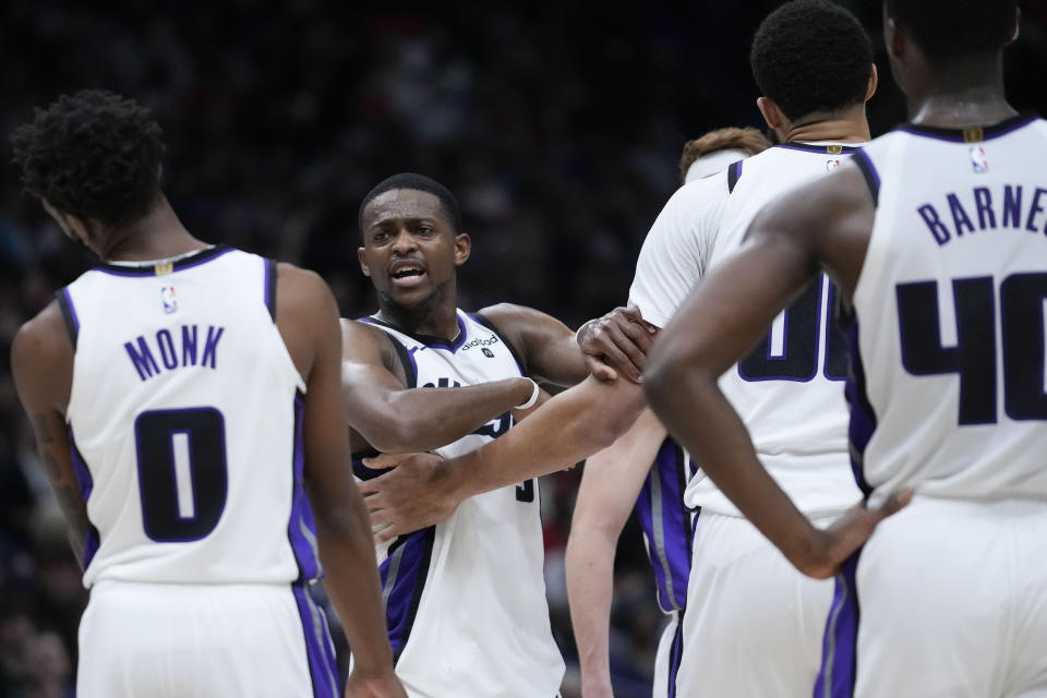 Sacramento Kings guard De'Aaron Fox (5) is restrained by teammates as he argues with an official, which resulted in a technical foul, in the second half of an NBA basketball game against the New Orleans Pelicans in New Orleans, Wednesday, Nov. 22, 2023. The Pelicans won 117-112. (AP Photo/Gerald Herbert)