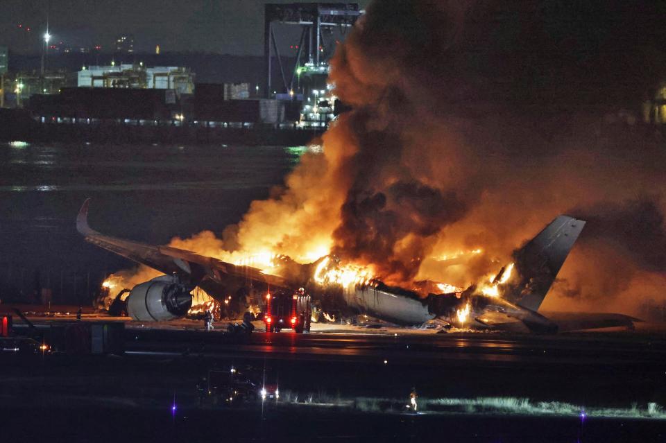 A Japan Airlines jet on fire after colliding with another plane on the runway of Haneda airport on Tuesday in Tokyo.