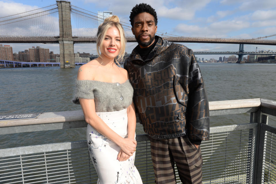 Sienna Miller and Chadwick Boseman pose during a photo call for 