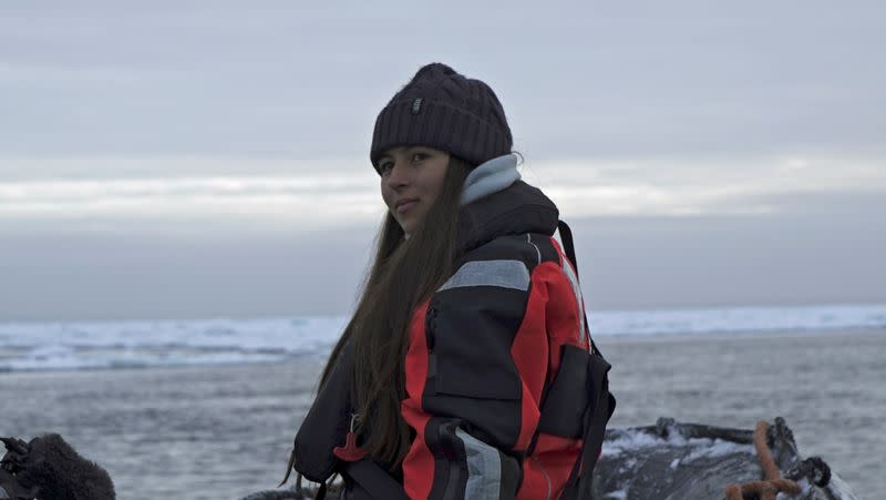 Environmental activist and campaigner Mya-Rose Craig sits on a boat in the middle of the Arctic Ocean