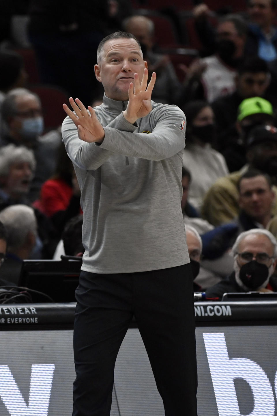 Denver Nuggets head coach Michael Malone signals to the team against the Chicago Bulls during the first half of an NBA basketball game, Monday, Dec. 6, 2021, in Chicago. (AP Photo/Matt Marton)