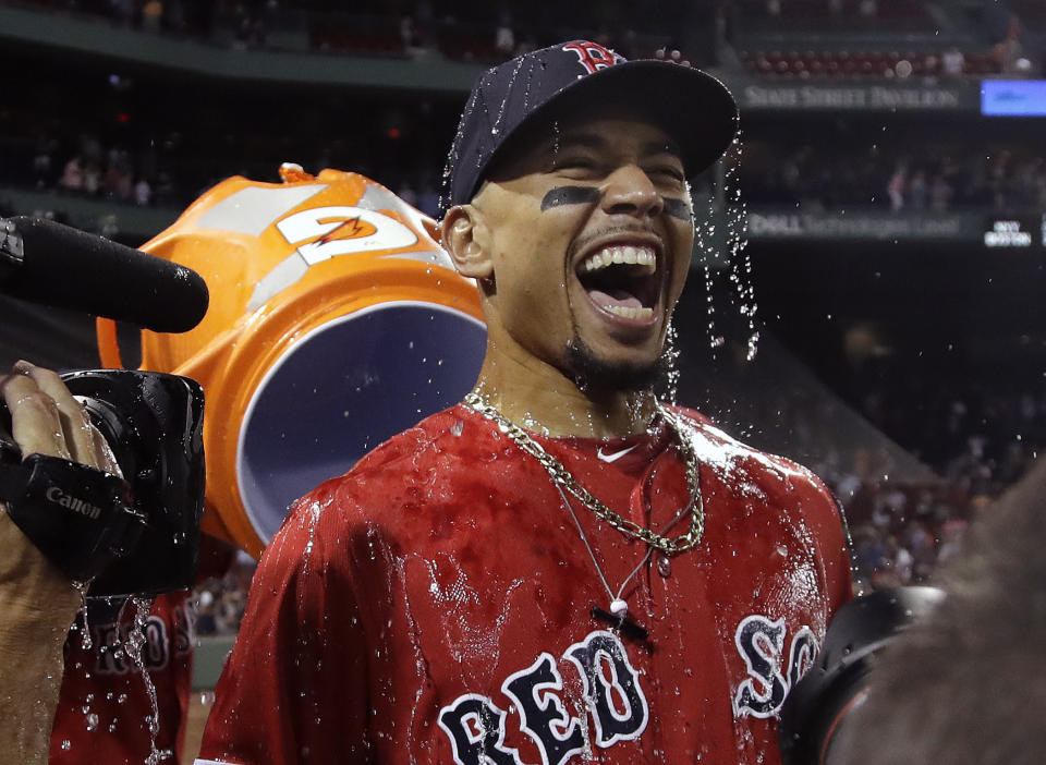 Boston Red Sox's Mookie Betts is doused after their victory over the New York Yankees in a baseball game at Fenway Park, Friday, July 26, 2019, in Boston. (AP Photo/Elise Amendola)