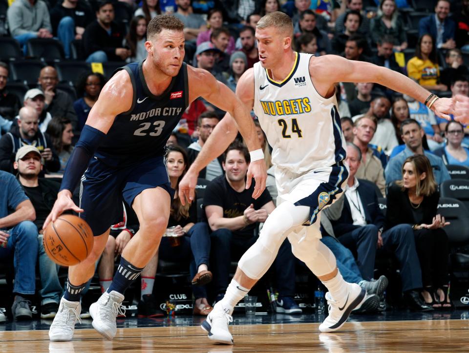 Pistons forward Blake Griffin drives past Nuggets center Mason Plumlee in the first half Thursday, March 15, 2018 in Denver.