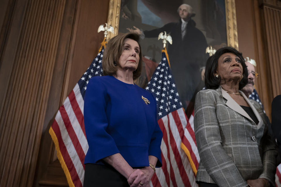 Speaker of the House Nancy Pelosi, D-Calif., left, and House Financial Services Committee Chairwoman Maxine Waters, D-Calif., join other committee chairs to announce they are pushing ahead with two articles of impeachment against President Donald Trump — abuse of power and obstruction of Congress — charging he corrupted the U.S. election process and endangered national security in his dealings with Ukraine, at the Capitol in Washington, Tuesday, Dec. 10, 2019. (AP Photo/J. Scott Applewhite)