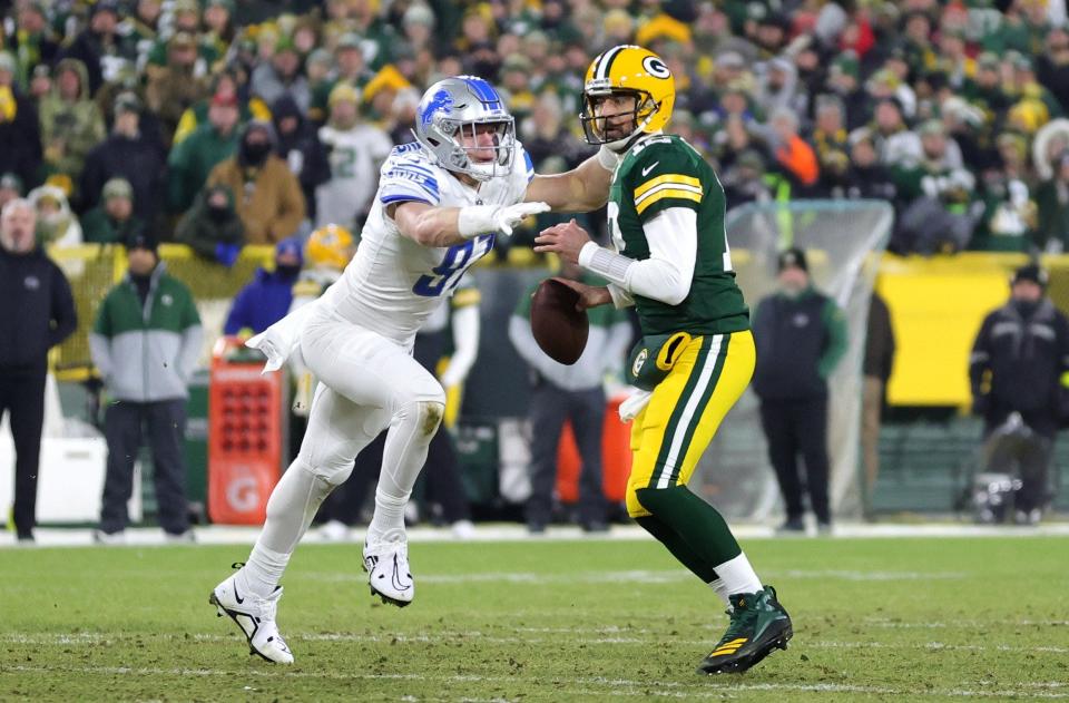 Lions defensive lineman Aidan Hutchinson sacks Packers quarterback Aaron Rodgers during the first half on Sunday, Jan.  8, 2023, in Green Bay, Wisconsin.