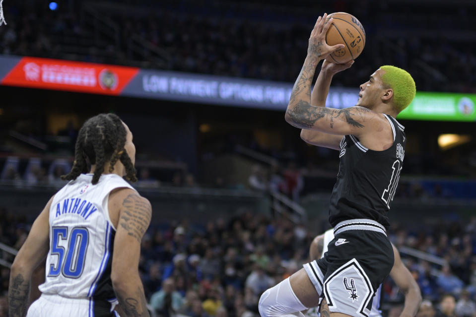 San Antonio Spurs forward Jeremy Sochan (10) goes up for a shot in front of Orlando Magic guard Cole Anthony (50) during the first half of an NBA basketball game Friday, Dec. 23, 2022, in Orlando, Fla. (AP Photo/Phelan M. Ebenhack)