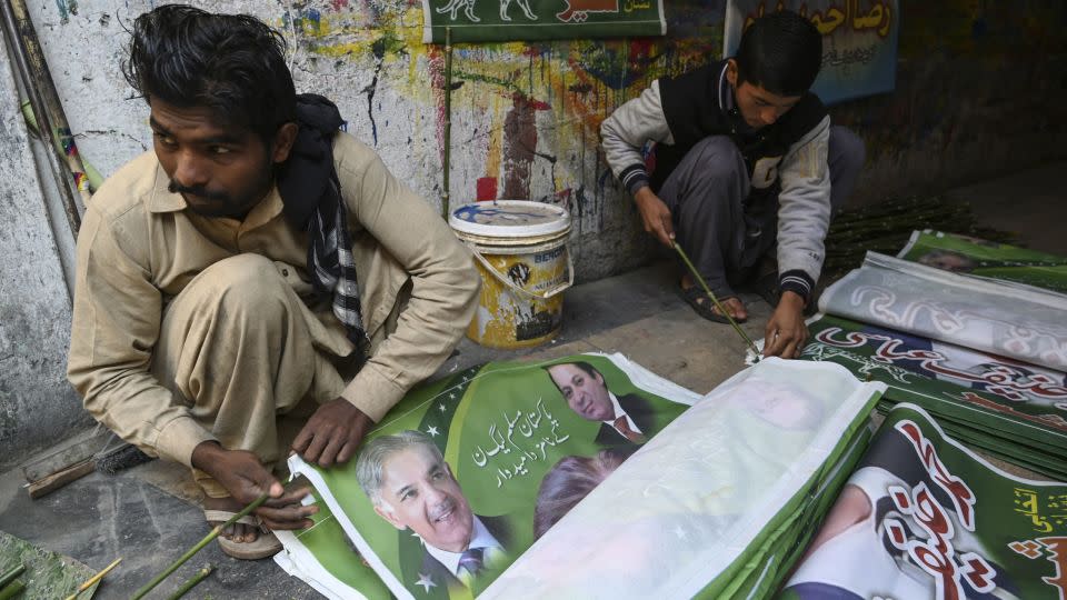Workers prepare election campaign posters of the Pakistan Muslim League (N) party in Rawalpindi on January 10, 2024. - Aamir Qureshi/AFP/Getty Images