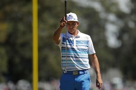 Rickie Fowler lines up a putt on the first green in third round play during the 2017 Masters golf tournament at Augusta National Golf Club in Augusta, Georgia, U.S., April 8, 2017. REUTERS/Brian Snyder