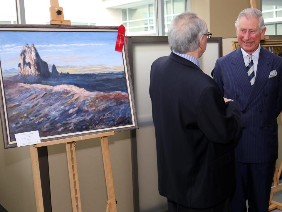 Prince Charles and Camilla with one of his paintings.