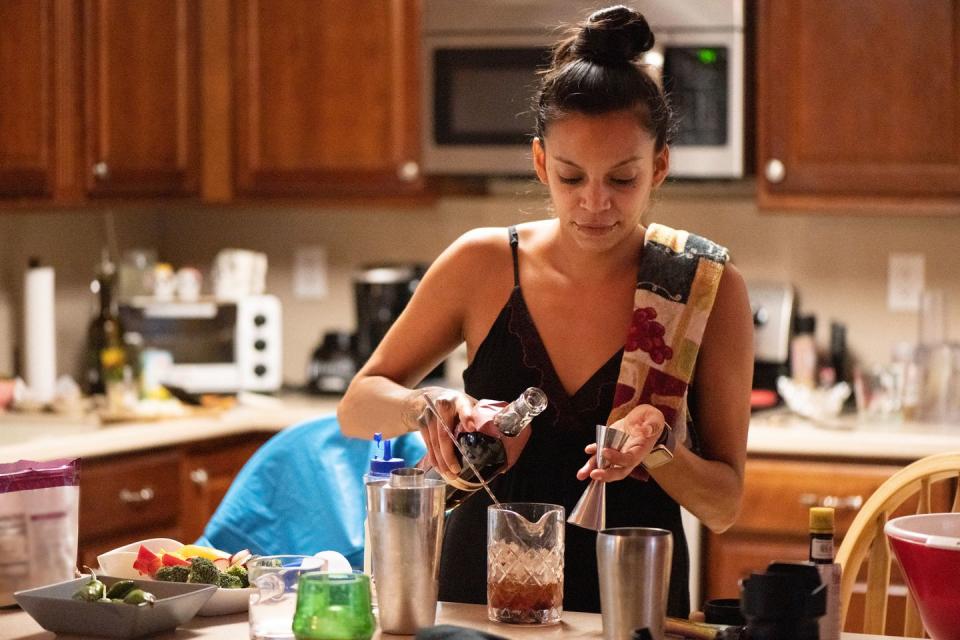 30 year old hispanic woman bartender making drinks at home in florida usa