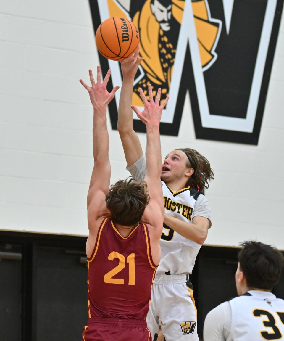 Carter Warstler scores two of his 25 points in The College of Wooster's NCAC Tournament win over Oberlin.