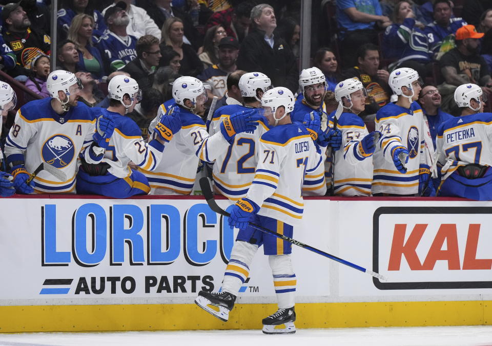 Buffalo Sabres' Victor Olofsson (71) is congratulated for his goal against the Vancouver Canucks during the third period of an NHL hockey game Saturday, Oct. 22, 2022, in Vancouver, British Columbia. (Darryl Dyck/The Canadian Press via AP)