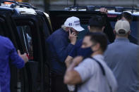 President Donald Trump talks on the phone as he arrives at the White House after golfing Saturday, Nov. 7, 2020, in Washington. (AP Photo/Evan Vucci)