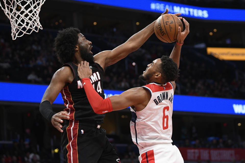 Miami Heat forward Solomon Hill (44) blocks Washington Wizards forward Troy Brown Jr. (6) during the second half of an NBA basketball game, Sunday, March 8, 2020, in Washington. The Heat won 100-89. (AP Photo/Nick Wass)